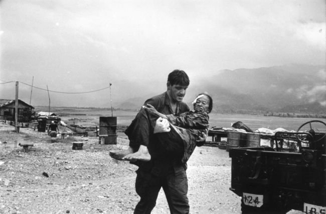 US Marine Carrying Vietnamese Refugee