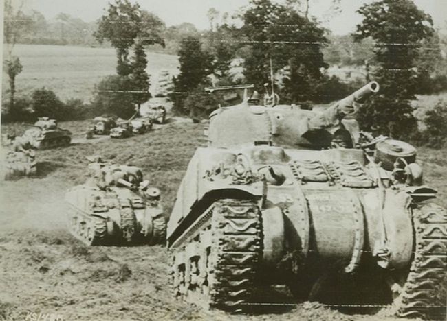 BRITISH TANKS MOVE UP TO FRONT