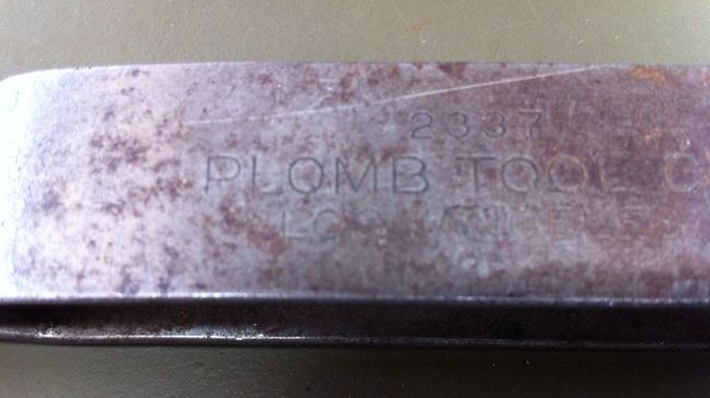 Round O Plomb logo on early scraper