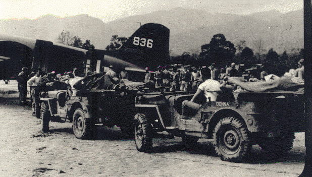 Ambulance Jeeps loading wounded on transports